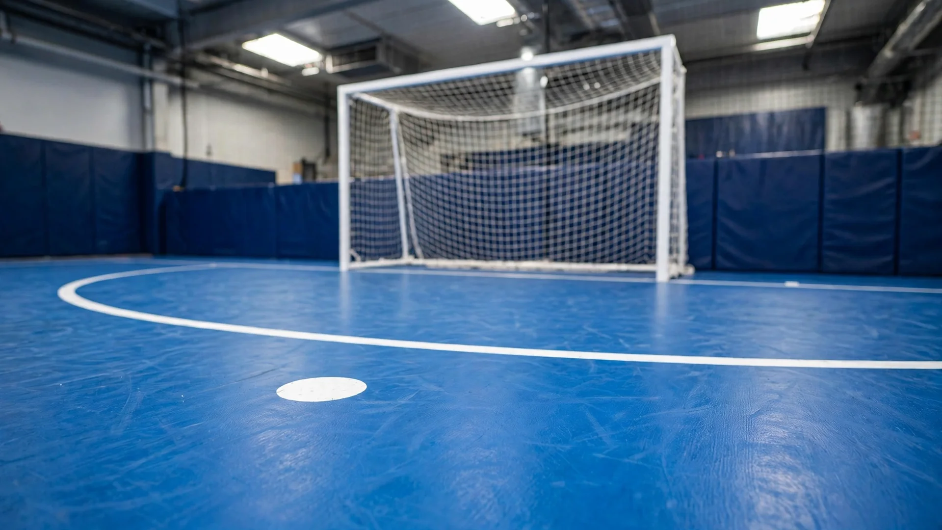 Futsal penalty area with 6m arc, penalty mark and goal on an indoor court